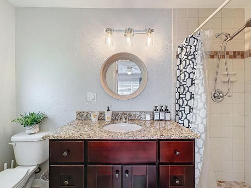 a bathroom with a sink and a mirror at Largo Pool House Firepit Pet Friendly in Largo