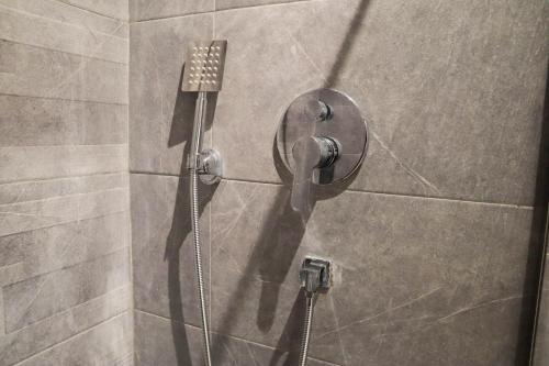 a shower stall with a shower head in a bathroom at R108- Gorgeous & Cosy Aprt with Wifi, Parking and Gym at the heart of Bourgogne in Casablanca-Port
