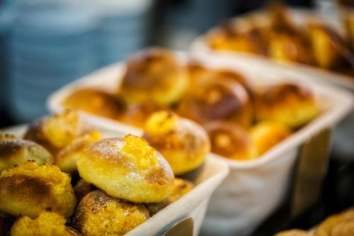 a bunch of donuts in trays on a table at Altis Suites Apartamentos Turísticos in Lisbon