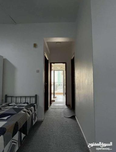 a hallway with two beds in a room at Sharing flat for LADIES ONLY in Sharjah