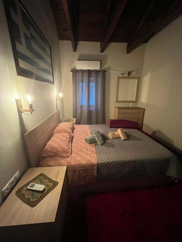 a small bedroom with two beds and a table at Despo's Guest House in Kandíla
