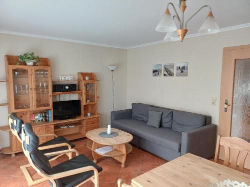 ein Wohnzimmer mit Sofa und Tisch in der Unterkunft Moderne Ferienwohnung in Pudagla mit Grill, Garten und Terrasse in Pudagla