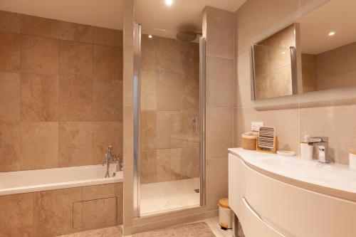 a bathroom with a shower and a tub and a sink at Villa Soleil Et Douceur in La Seyne-sur-Mer