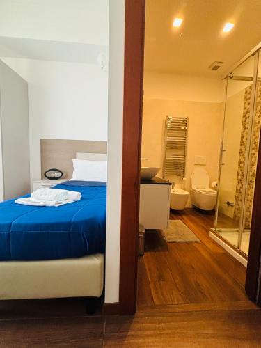 a bedroom with a bed and a bathroom at Enjoy Milano Skyline in Milan