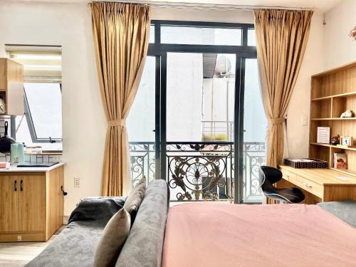 a bedroom with a bed and a balcony at Four P Home in Ho Chi Minh City