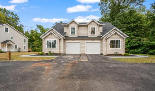 a large house with a garage on a driveway at Ideal Family Stay Sleeps 20 in Bloomfield, CT in Bloomfield