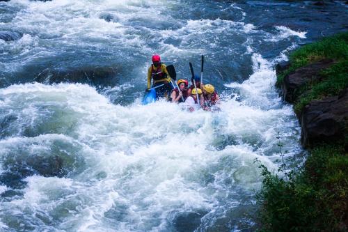 a group of people in a raft in a river at Eco Lodges by Ceylon Adventures in Kitulgala
