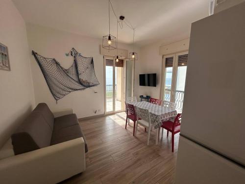 a living room with a couch and a table at Attico Galilei Fronte Mare by Salentoville Gallipoli in Gallipoli