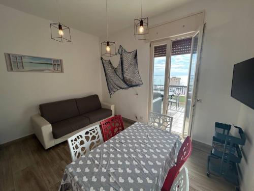 a living room with a couch and a table at Attico Galilei Fronte Mare by Salentoville Gallipoli in Gallipoli