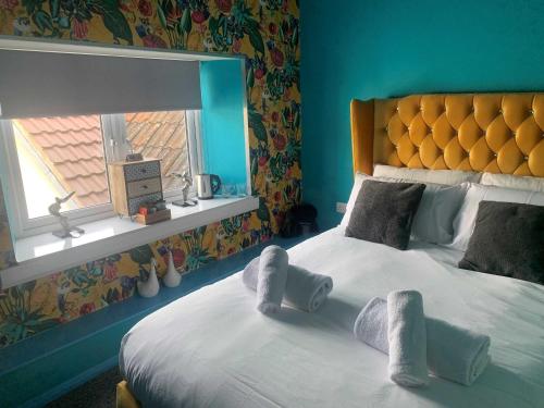 a bedroom with a bed with towels on it at The Poacher Portishead in Portishead