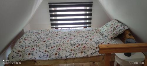 a bed in a room with a window at Holiday home Vukovoj in Klenovnik