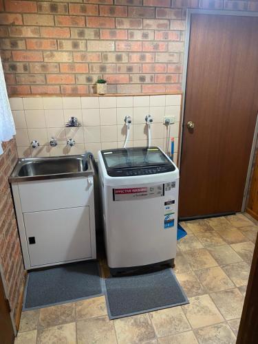 a small kitchen with a sink and a counter at Yarrawonga Holiday Unit in Yarrawonga