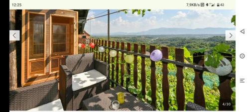 a balcony of a house with a view of the mountains at Holiday home Vukovoj in Klenovnik