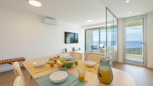 a dining room with a table and a view of the ocean at Casa do Xano I by LovelyStay in Câmara de Lobos