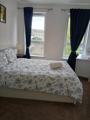 a bedroom with a bed and a large window at Cosy double room in Canada Water in London