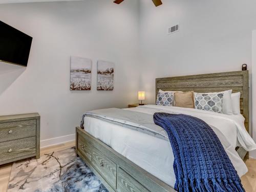 a bedroom with a large bed and a flat screen tv at Lazy Hammock in Tybee Island