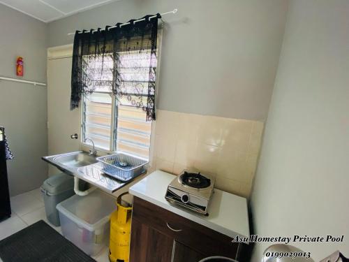 a small kitchen with a sink and a window at Asu Homestay w Private Pool - Batu Gajah,Perak in Batu Gajah