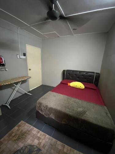 a bedroom with a bed with a banana on it at Asu Homestay w Private Pool - Batu Gajah,Perak in Batu Gajah