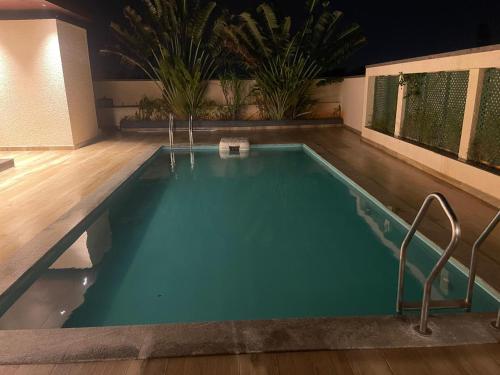 a large swimming pool in a house with aperature at VINTAGE VISTA RESORTs in Chennai