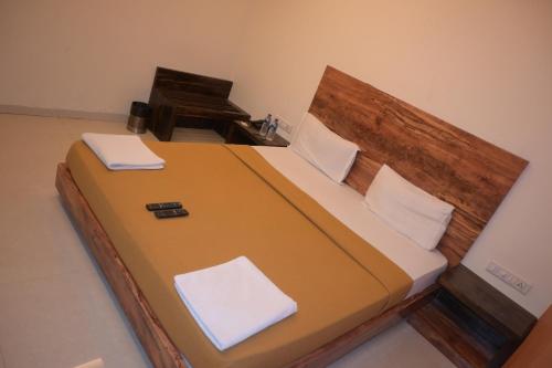 a bedroom with a bed and a piano at Hotel Royal Residency in Umele