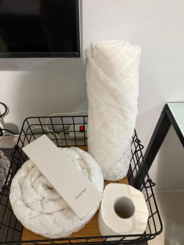 a basket of toilet paper and a laptop on a table at RGM PLACE in Davao City