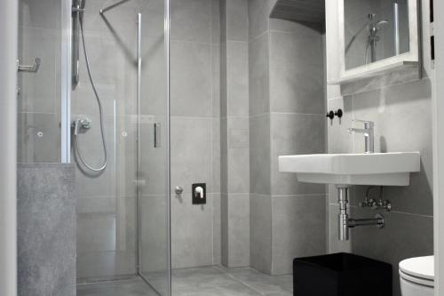 a bathroom with a shower and a sink at KAVE Obchodná Apartments in Bratislava