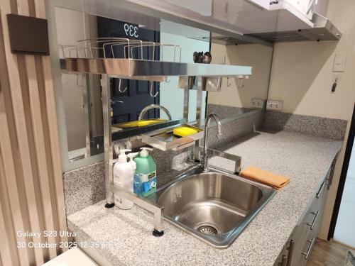a kitchen sink with a faucet in a kitchen at Luna's Place in Sampong