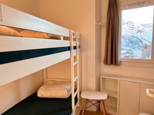 a room with two bunk beds and a chair at Appartement scandinave rénové, skis aux pieds, 7 pers. - FR-1-634-6 in Avoriaz