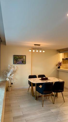 a dining room with a table and chairs at Centaurus Two Bed Mountain View in Islamabad