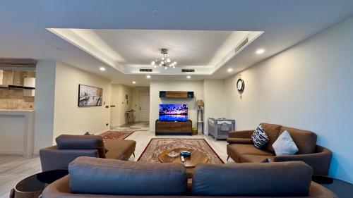 a large living room with couches and a tv at Centaurus Three Bed Mountain View in Islamabad