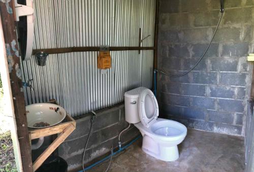 a bathroom with a toilet and a sink at Sparrow Hut in Pai