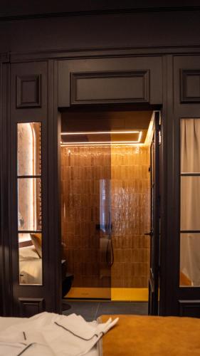 a bathroom with a shower with a glass door at Boada Riera - The RoomsbyReini in Terrassa