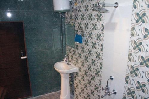 a bathroom with a toilet and a sink and a shower at Sunny Ridge Homesty in Cherrapunji
