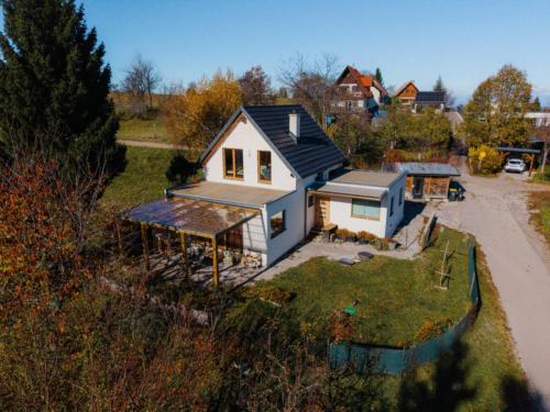 an overhead view of a white house with a roof at Naravna lesena hiša v naravi z lastnim vrtom in Ig
