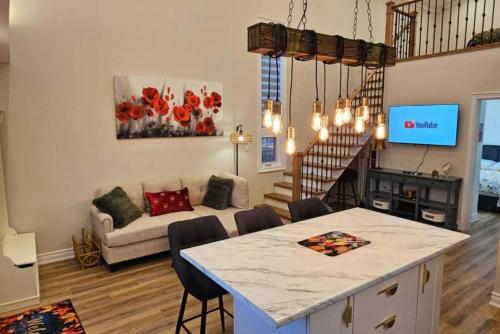 a kitchen and living room with a table and a couch at Luxury Family House 3 beds, 1 bath, 5 guest in Toronto