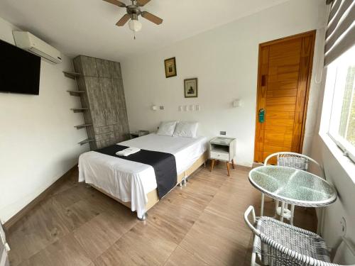 a bedroom with a bed and a table and a window at Golden Suite Miraflores 