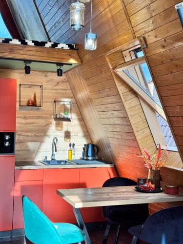 an attic kitchen with a table and chairs at A-frame-hub in Slavske