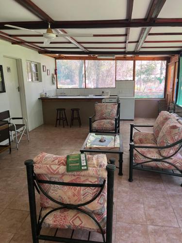 a living room with two chairs and a table at Proudly Okavango self-catering Burnside in Shakawe