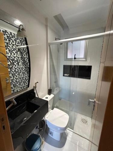 a bathroom with a shower and a toilet and a sink at COP 30 aconchego e conforto in Ananindeua