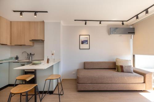 salon z kanapą i kuchnią w obiekcie RQ Providencia w mieście Santiago
