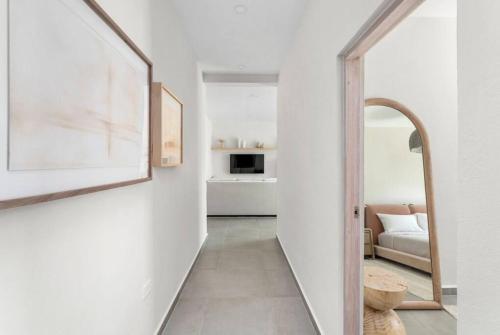 a hallway leading to a living room with a mirror at Casa Loba Luxe Unit 2 with private pool and garden in Rincon