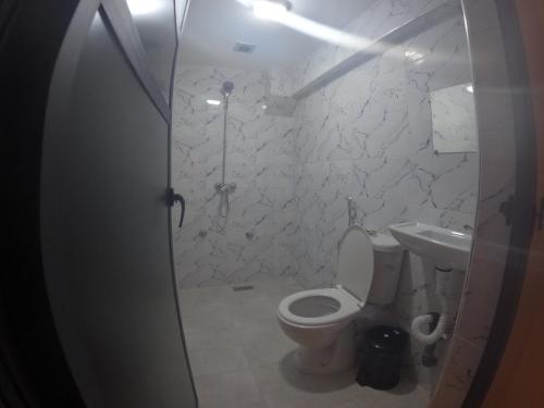 a bathroom with a toilet and a sink at Tayoukhte Surf Camp Imsouane in Imsouane