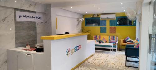 a room with a counter and a living room at goSTOPS PLUS Goa, Vagator in Goa Velha