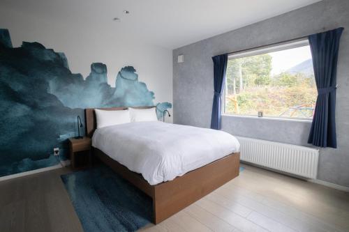 Postel nebo postele na pokoji v ubytování Grey House Niseko