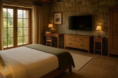 a bedroom with a bed and a desk and a television at Serokan The Anami in Cai Be