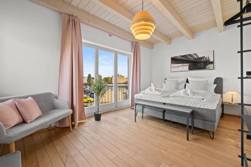 a bedroom with a large bed and a couch at Svyvo Cologne-Esch Design Apartment in Cologne