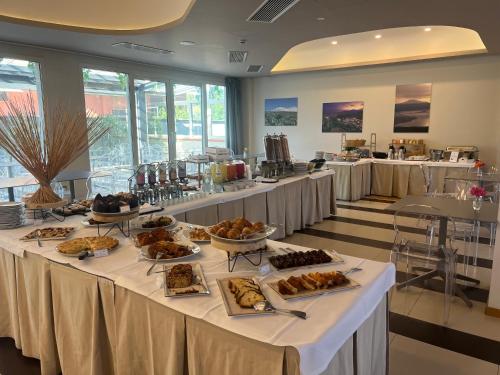 a long table with food on it in a room at Mareneve Resort in Linguaglossa