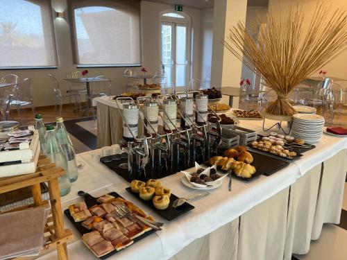 a buffet of food on a table in a room at Mareneve Resort in Linguaglossa