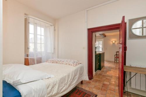 ein Schlafzimmer mit großem Bett und Fenster in der Unterkunft Au Cœur De Guérande - Intra Muros in Guérande