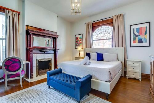 a bedroom with a bed and a chair and a fireplace at 6br New Orleans Speakeasy Hot Tub & Playground in Louisville